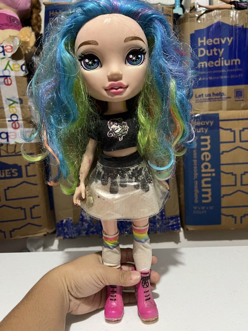 Rainbow High Dolls - Blue & Rainbow Hair (Category: Kids Toys) located in Bugallon. Submitted by aennleeza (Listing ID 1457161288, Image 3). Description: - Two Rainbow High dolls sold as a set. - Doll 1: Blue hair, light blue jacket, patterned skirt. - Doll 2: Multi-colored hair, black crop top, sparkly skirt. - Both dolls feature colorful socks and boots. - Selling as a pair, as seen in photos..
