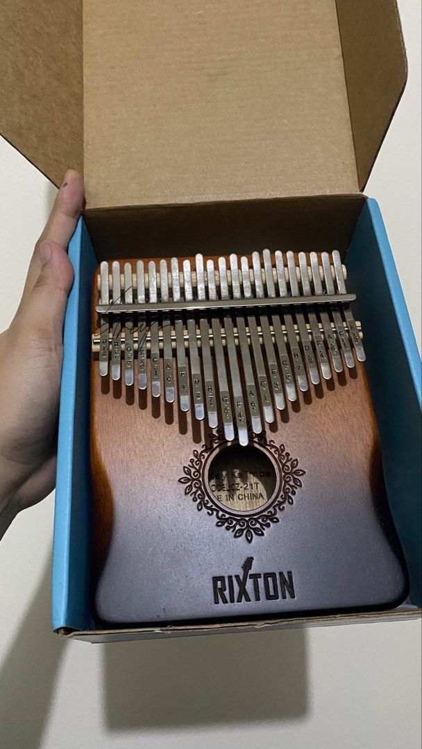 Rixton Kalimba 17 Keys <decluttering> (Category: Musical Instruments) located in Santa Rosa. Submitted by hadassa_grace (Listing ID 1457267893, Image 1). Description: - Rixton 17-key Kalimba - Made in China - Includes learning book - Includes tuning hammer - Decorative gift box with deer design - Ideal for beginners and aspiring musicians.