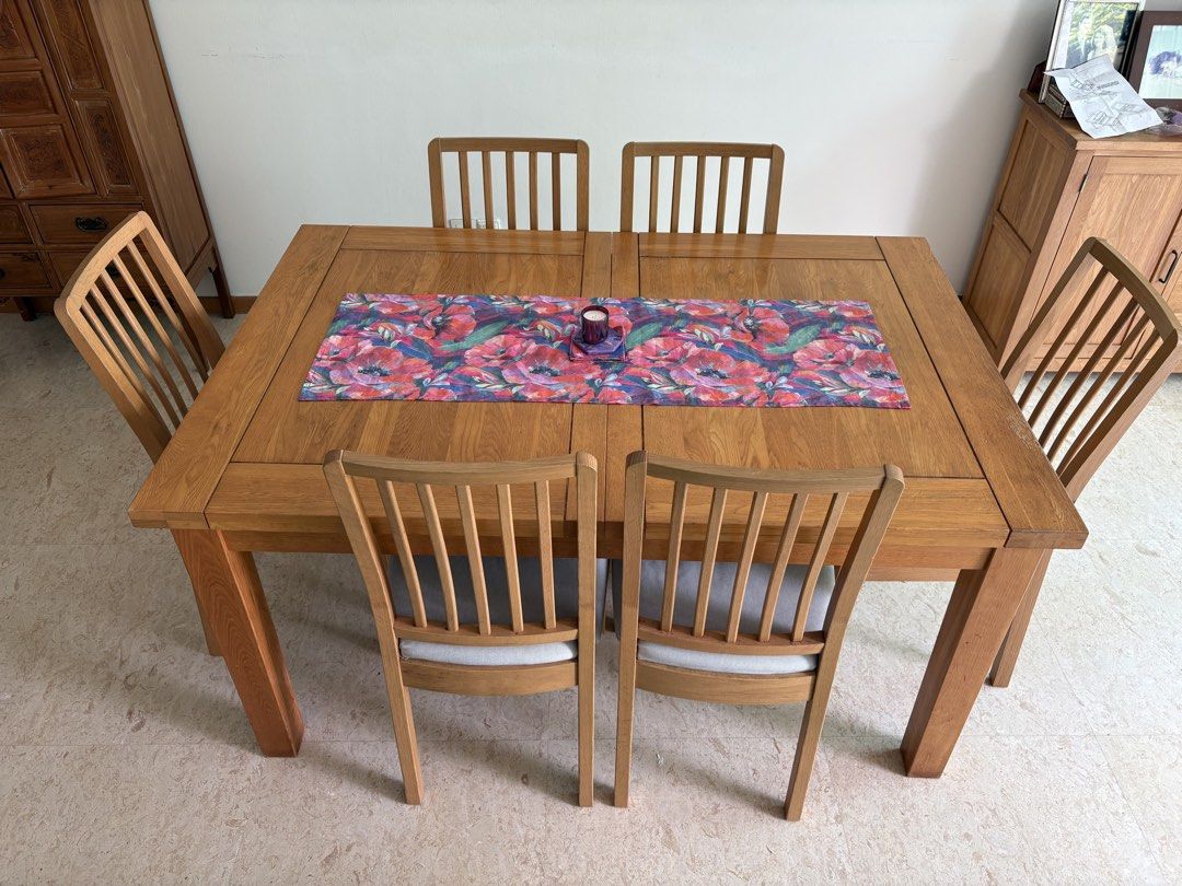 Solid Wood Dining Table with 6 dining chairs (Category: Tables & Sets) located in Singapore. Submitted by minky.h (Listing ID 1457213605, Image 1). Description: Solid Wood Dining Table, some slight signs of wear and tear but in very condition. 150 cm x 100 cm Height 76 cm When extended Table 210 cm x 100cm Height 76 cm Six dining chairs, in excellent condition, with removable, washable seat covers. .