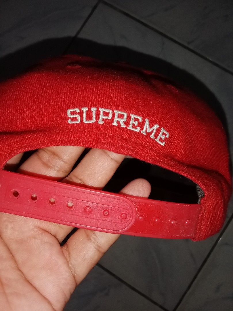 Supreme USA Globe Flames Red Snapback Hat (Category: Caps & Hats) located in Iloilo. Submitted by bakerzero8 (Listing ID 1457316391, Image 2). Description: - Authentic Red Supreme Snapback Cap - Iconic globe with flames logo on the front - 'Supreme' text embroidered on the back - 'Made in USA' tag visible - Adjustable snap closure for a custom fit.