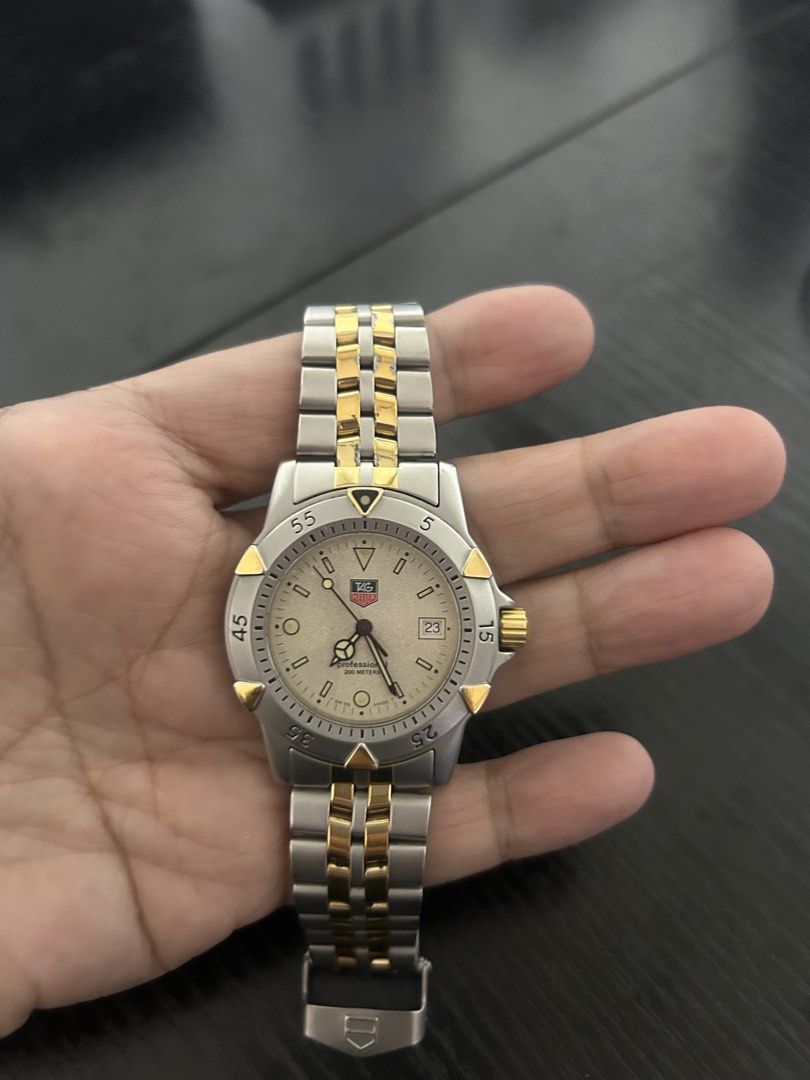 TAG Heuer Professional 200m Two-Tone Watch (Category: Luxury Watches) located in Taguig. Submitted by prelovedby_zia (Listing ID 1457258231, Image 1). Description: - Authentic TAG Heuer Professional Watch - Two-tone Stainless Steel and Gold Bracelet - Date Window at 3 o'clock - Water Resistant 200m - Durable Sapphire Crystal - Swiss Made Quality - Secure Clasp - Minor signs of wear on bracelet -Newly replaced battery - With extra link.