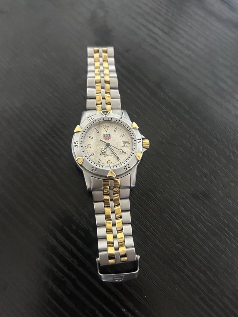 TAG Heuer Professional 200m Two-Tone Watch (Category: Luxury Watches) located in Taguig. Submitted by prelovedby_zia (Listing ID 1457258231, Image 2). Description: - Authentic TAG Heuer Professional Watch - Two-tone Stainless Steel and Gold Bracelet - Date Window at 3 o'clock - Water Resistant 200m - Durable Sapphire Crystal - Swiss Made Quality - Secure Clasp - Minor signs of wear on bracelet -Newly replaced battery - With extra link.