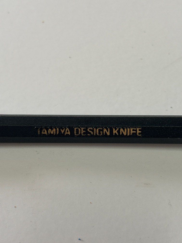 Tamiya Design Knife (Item 74020) (Category: Stationery & School Supplies) located in Bulacan. Submitted by ourdailybreads (Listing ID 1457170560, Image 1). Description: Tamiya Design Knife (Item 74020) featuring a slim black pen-style handle with gold lettering and a translucent protective cap..