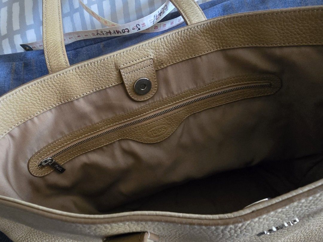 TOD'S Leather Tote Bag (Category: Luxury Bags & Wallets) located in Pasig City. Submitted by jdv1974 (Listing ID 1457155582, Image 2). Description: - Classic tan leather tote bag from TOD'S - Pebbled leather exterior - Spacious interior with a zippered pocket - Magnetic snap closure - Comfortable shoulder straps - Great for everyday use or travel.