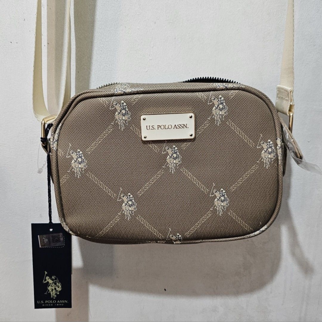 U.S. Polo Assn. Crossbody Bag (Category: Cross-body Bags) located in Manila. Submitted by cacnammon (Listing ID 1457189363, Image 2). Description: - Brand: U.S. Polo Assn. - Color: Brown/Beige - Style: Crossbody bag - Features: Signature monogram pattern all over - Compartments: Main zippered compartment with an inner pocket - Strap: Adjustable - Condition: Brand new with original tags attached - Ideal for: Everyday use.