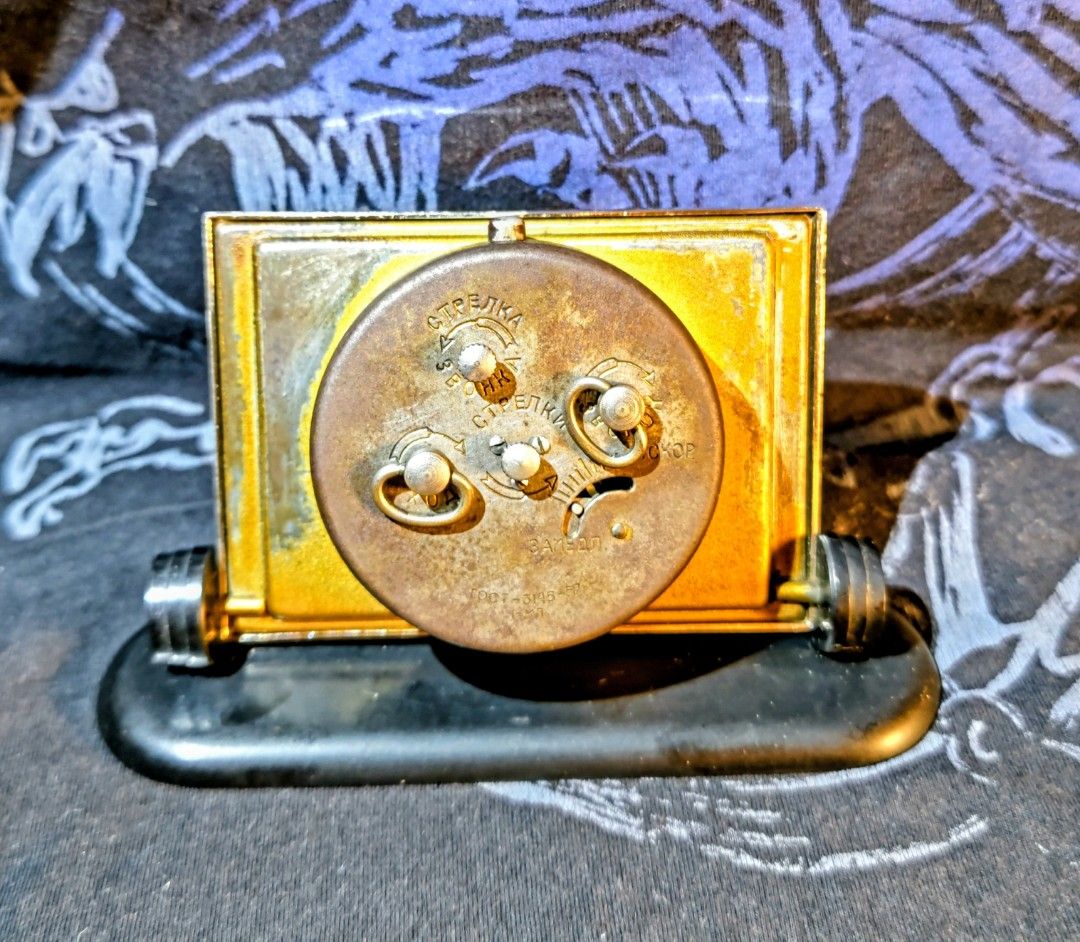 Vintage USSR Mechanical Desk Clock (Category: Clocks) located in Bocaue. Submitted by zoltanmagy29168 (Listing ID 1457160968, Image 2). Description: - Vintage mechanical desk clock from the USSR. - Classic analog face with gold-tone hands. - Features winding mechanisms and settings on the back - Ideal for collectors or as a unique decorative item. -Perfectly functional..