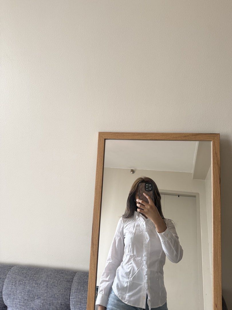 White Button-Up Shirt (Category: Longsleeves) located in Manila. Submitted by ej_guyud00 (Listing ID 1457202894, Image 2). Description: 💌 Classic white button-up shirt with ruffles 💌 Long sleeves with button cuffs 💌 Unique gathered/ruched detail on the front placket 💌 Versatile for work or casual outfits 💌 Fits to XS-S.
