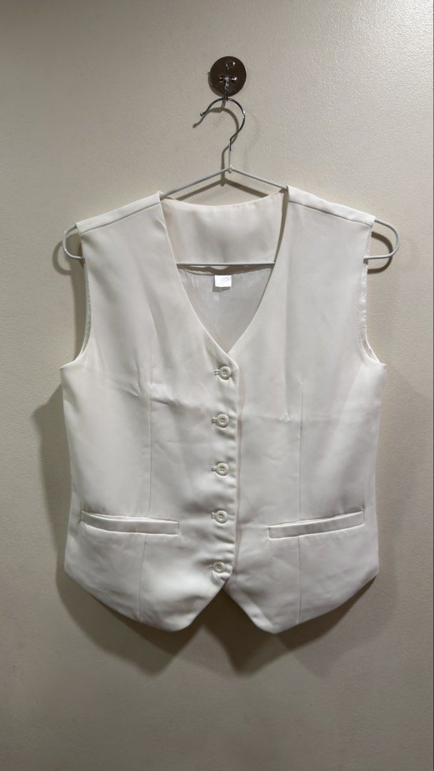 White Formal Vest (Category: Vests) located in Cebu City. Submitted by ngl.prelovedstuff (Listing ID 1457155612, Image 1). Description: - Classic white vest - Button-front closure - Two functional front pockets - Adjustable strap at the back for a customized fit - Smooth, comfortable material - Ideal for formal occasions or as part of a uniform - Excellent layering piece.