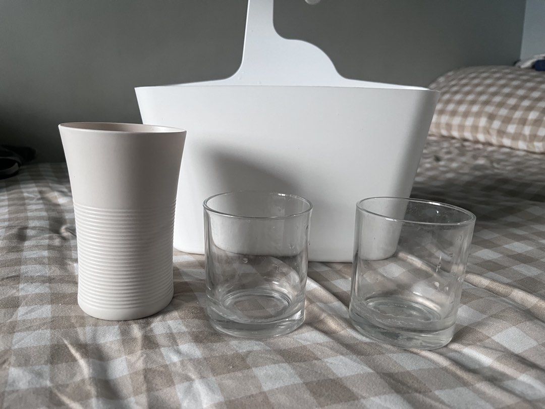 White hanging storage basket with 3 cups (Category: Storage Boxes & Baskets) located in Makati City. Submitted by spicychickensandwich (Listing ID 1457304215, Image 1). Description: - White plastic storage basket with convenient hanging hook - Includes three cups: one beige tumbler and two clear glass tumblers - Ideal for organizing items in your bathroom or kitchen - Sold as a complete set.