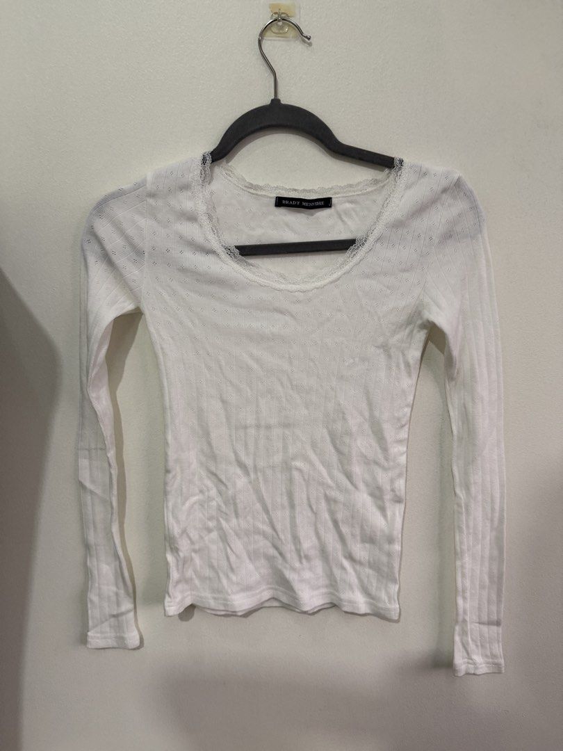 White Pointelle Knit Long Sleeve Top (Category: Longsleeves) located in Muntinlupa City. Submitted by jtarchive (Listing ID 1457256970, Image 1). Description: - Brandy Melville similar long sleeve top - Ribbed material - Delicate lace trim neckline - Small eyelet details on shoulders and sleeves - Cute and dainty design - Ideal for layering or wearing solo.