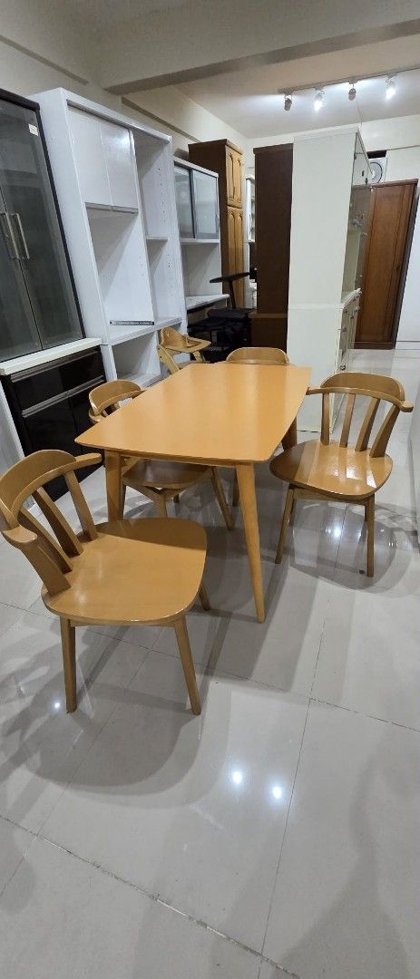 Wooden Dining Table and 4 Chairs Set (Category: Tables & Sets) located in Quezon City. Submitted by jmandchad143 (Listing ID 1457150511, Image 1). Description: - Complete dining set: 1 table and 4 chairs - Beautiful warm, orange-toned wood finish - Classic spindle back chair design - Smooth, lacquered table top - Sturdy and comfortable chairs - Ideal for small dining areas or kitchens - Rotating chairs .