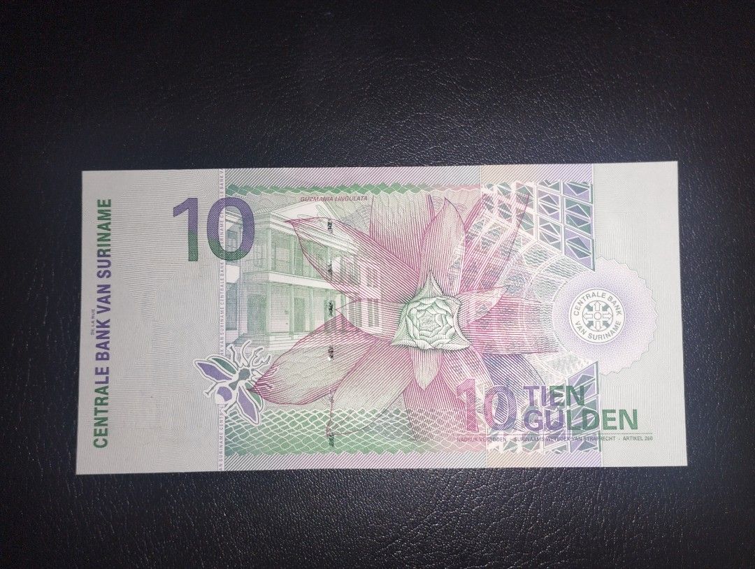 10 Gulden Suriname (Category: Currency) located in Baguio. Submitted by maximum_carnage (Listing ID 1457432479, Image 2). Description: - 10 Surinamese Gulden banknote - Features a hummingbird on the front - Large flower design on the back - Serial number: AS58867 - Ideal for coin and currency collectors.