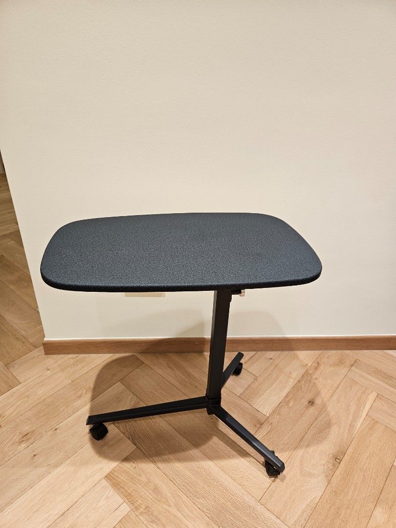Adjustable Rollable Side Table (Category: Tables & Sets) located in Singapore. Submitted by theangfamily (Listing ID 1457436698, Image 2). Description: - Portable side table stand - Adjustable height. - Built-in wheels for easy mobility - Textured dark grey hard top surface - Sturdy black metal frame - Ideal for sofa side table or corner table - Table top: 61cm x 37cm. height is adjustable. .