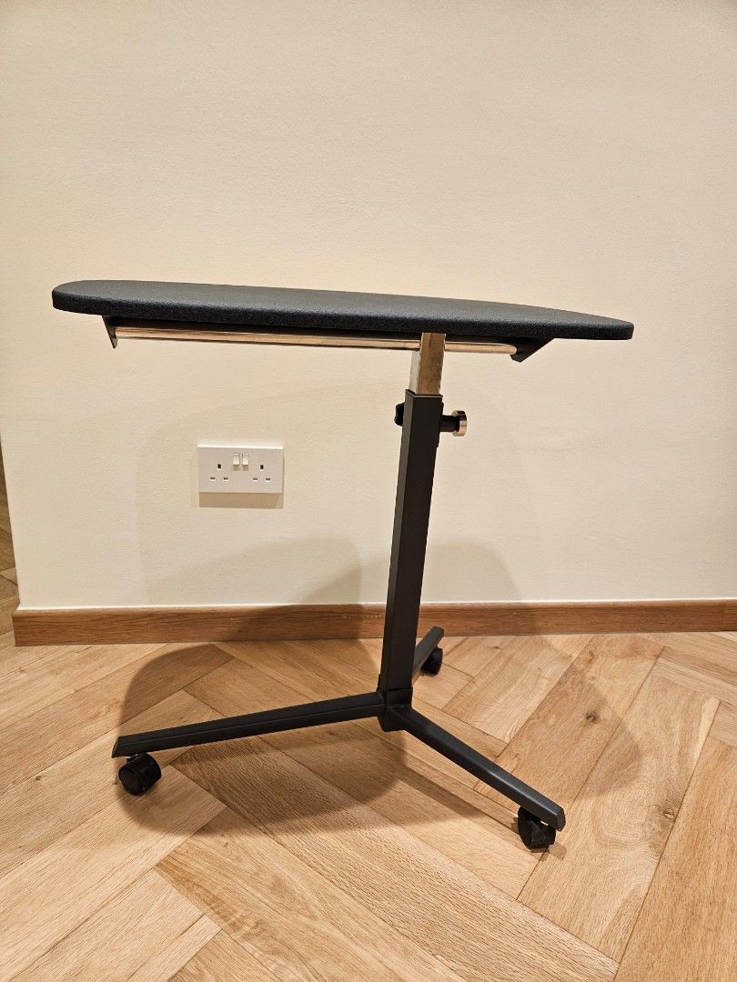 Adjustable Rollable Side Table (Category: Tables & Sets) located in Singapore. Submitted by theangfamily (Listing ID 1457436698, Image 1). Description: - Portable side table stand - Adjustable height. - Built-in wheels for easy mobility - Textured dark grey hard top surface - Sturdy black metal frame - Ideal for sofa side table or corner table - Table top: 61cm x 37cm. height is adjustable. .