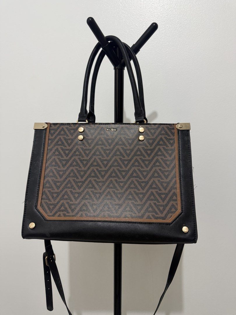 ALDO Monogram Tote Bag with Chain Detail (Category: Luxury Bags & Wallets) located in Manila. Submitted by dnnmrl (Listing ID 1457473879, Image 2). Description: - Stylish ALDO tote bag in brown and black. - Features the signature ALDO monogram print. - Elegant gold chain detail across the front. - Includes comfortable top handles. - Comes with a detachable shoulder strap for versatility. - Shows some signs of wear on handles and strap, adding cha