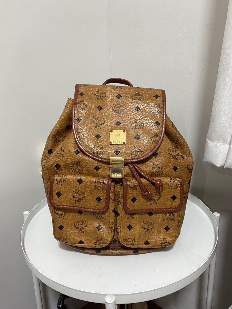 Authentic MCM Bagpack Cognac (Category: Luxury Bags & Wallets) located in Santa Rosa. Submitted by sassycollection. (Listing ID 1457424398, Image 2). Description: In good condition Cognac design Made in Germany Zip closure at the back Multi pocket Unisex.