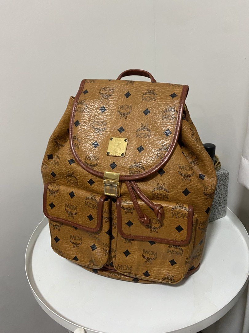 Authentic MCM Bagpack Cognac (Category: Luxury Bags & Wallets) located in Santa Rosa. Submitted by sassycollection. (Listing ID 1457424398, Image 1). Description: In good condition Cognac design Made in Germany Zip closure at the back Multi pocket Unisex.
