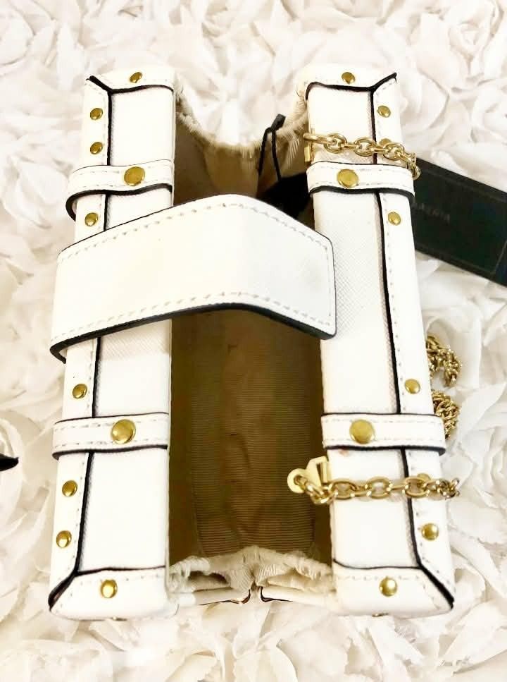 BCBG White structured handbag with gold chain detail (Category: Purses & Pouches) located in Imus. Submitted by sharislane (Listing ID 1457376766, Image 3). Description: - White structured handbag - Gold chain accents and hardware - Tan interior lining - Unique buckle closures - Ideal for night outs or statement outfits - Comes with original tag.