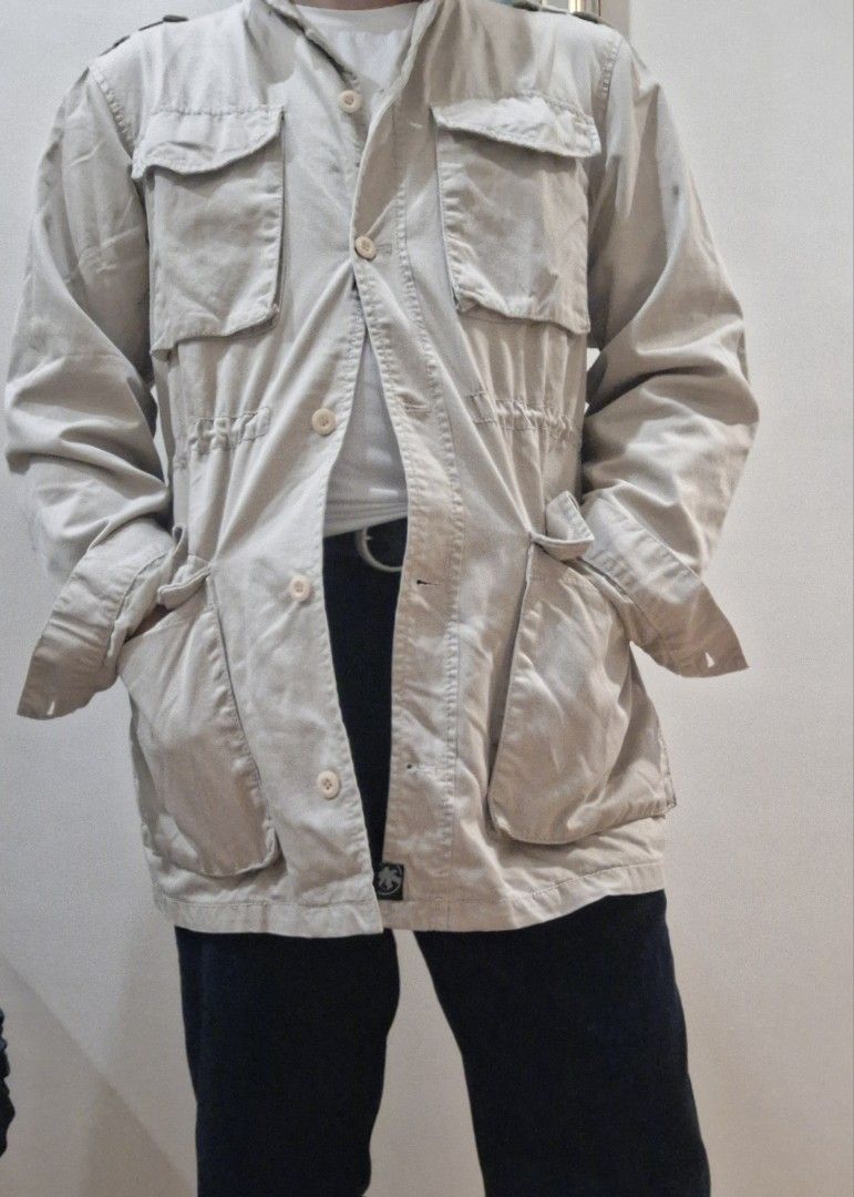 Beige Utility Jacket with Multiple Pockets (Category: Coats, Jackets and Outerwear) located in Baguio. Submitted by give_fad15730 (Listing ID 1457486074, Image 3). Description: -W:21in. -Shoulder:18in. -L:31in. -Arm:25in. - Cool beige utility jacket - Multiple front pockets for convenience - Drawstring waist for a cinched, adjustable fit - Button-up front closure - Ideal for layering - Pairs well with jeans or trousers - Perfect for casual wear.
