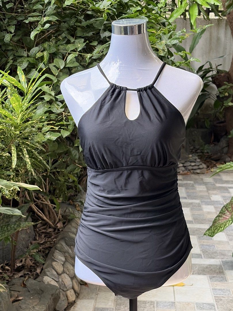 Black Halter Neck Ruched One-Piece Swimsuit (Category: Bikinis & Swimsuits) located in Taytay. Submitted by courtsidecloset (Listing ID 1457391432, Image 1). Description: - Elegant black one-piece swimsuit - Flattering halter neck with a chic keyhole cutout - Ruched detailing on the sides for a comfortable and slimming fit - Stylish criss-cross straps at the back - Perfect for beach or pool days.