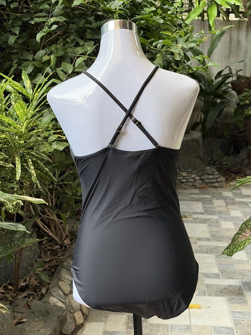 Black Halter Neck Ruched One-Piece Swimsuit (Category: Bikinis & Swimsuits) located in Taytay. Submitted by courtsidecloset (Listing ID 1457391432, Image 2). Description: - Elegant black one-piece swimsuit - Flattering halter neck with a chic keyhole cutout - Ruched detailing on the sides for a comfortable and slimming fit - Stylish criss-cross straps at the back - Perfect for beach or pool days.