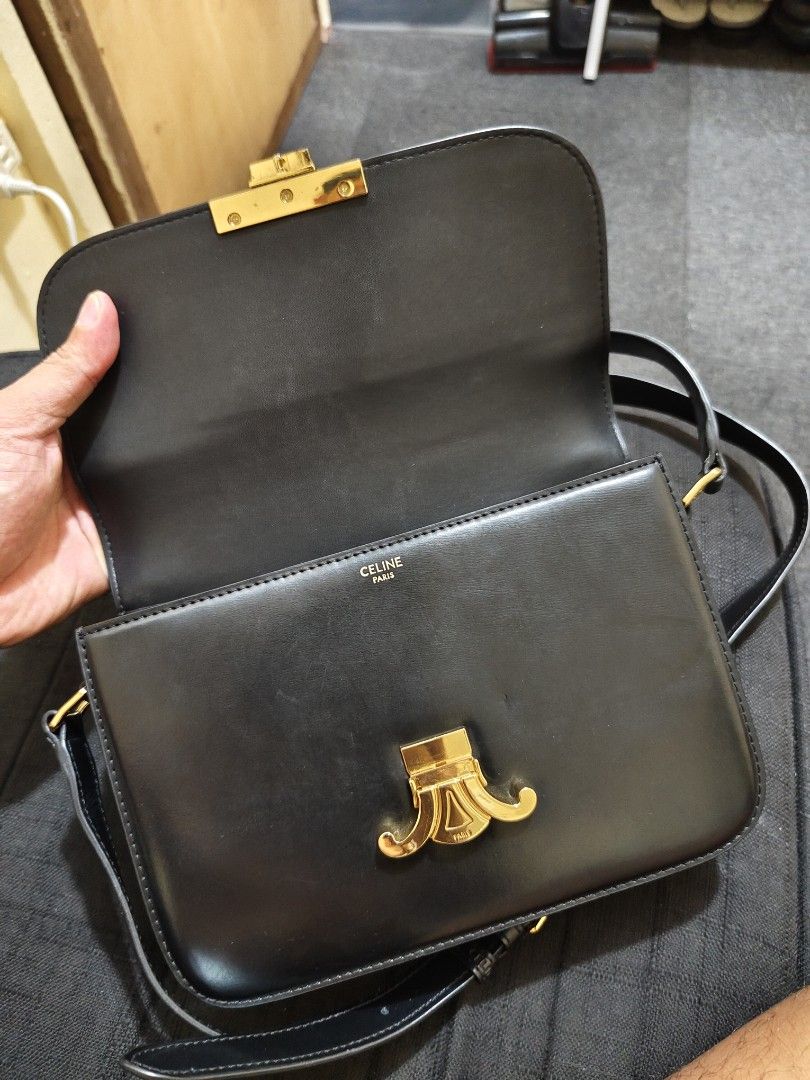 Celine Triomphe Bag Black Leather Gold Hardware (Category: Luxury Bags & Wallets) located in Manila. Submitted by wisemountain-ef2d99 (Listing ID 1457351997, Image 2). Description: - Authentic Black Leather Celine Bag - Iconic Gold Triomphe Clasp - Multiple Interior Compartments for Organization - Detachable Strap for Versatile Wear - Ideal for Day-to-Night Transitions.