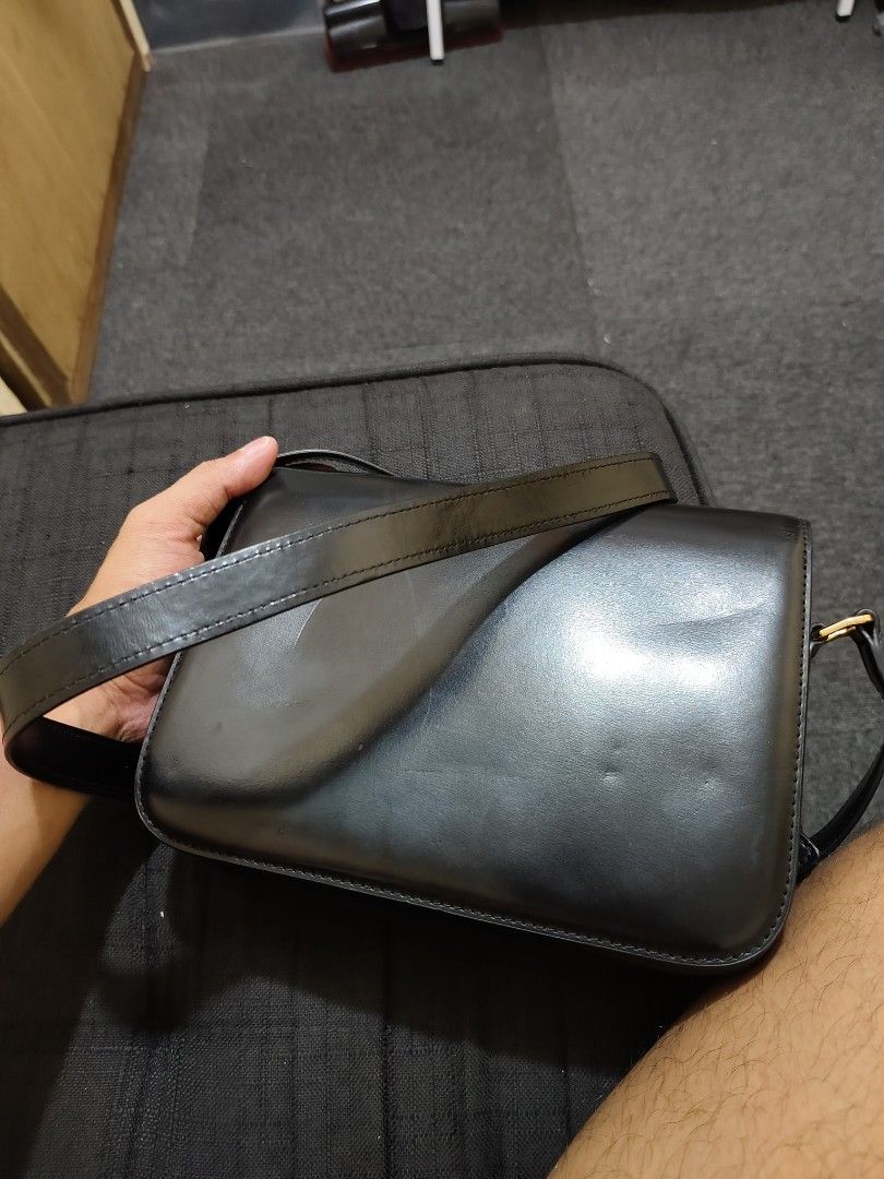 Celine Triomphe Bag Black Leather Gold Hardware (Category: Luxury Bags & Wallets) located in Manila. Submitted by wisemountain-ef2d99 (Listing ID 1457351997, Image 1). Description: - Authentic Black Leather Celine Bag - Iconic Gold Triomphe Clasp - Multiple Interior Compartments for Organization - Detachable Strap for Versatile Wear - Ideal for Day-to-Night Transitions.
