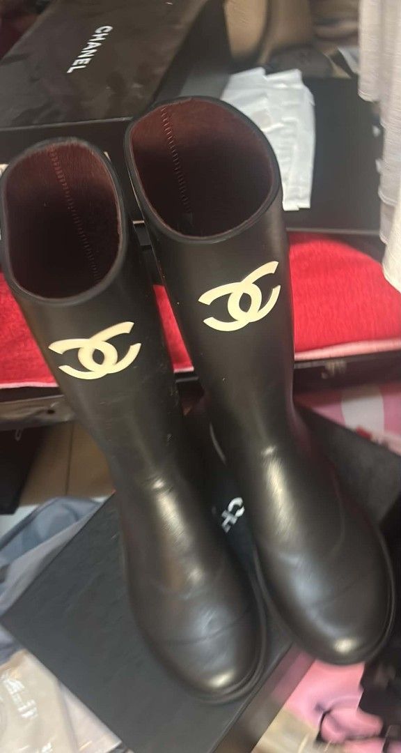 Chanel Black Rubber CC Logo Tall Rain Boots (Category: Sneakers & Footwear) located in Quezon City. Submitted by melmgpy (Listing ID 1457466008, Image 1). Description: - Classic black Chanel rain boots - Iconic CC logo on the side - Tall shaft design - Durable rubber material - Comfortable burgundy interior lining - Comes with original dust bags.