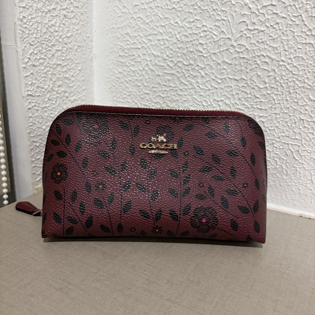 Coach Floral Zip Willow Cosmetic Pouch (Category: Luxury Bags & Wallets) located in Manila. Submitted by tidyspace.ph (Listing ID 1457372986, Image 1). Description: - Cute Coach cosmetic bag - Burgundy color with black and pink floral print - Zipper closure with leather pull tab - Ideal for makeup or small essentials - Compact and easy to carry.