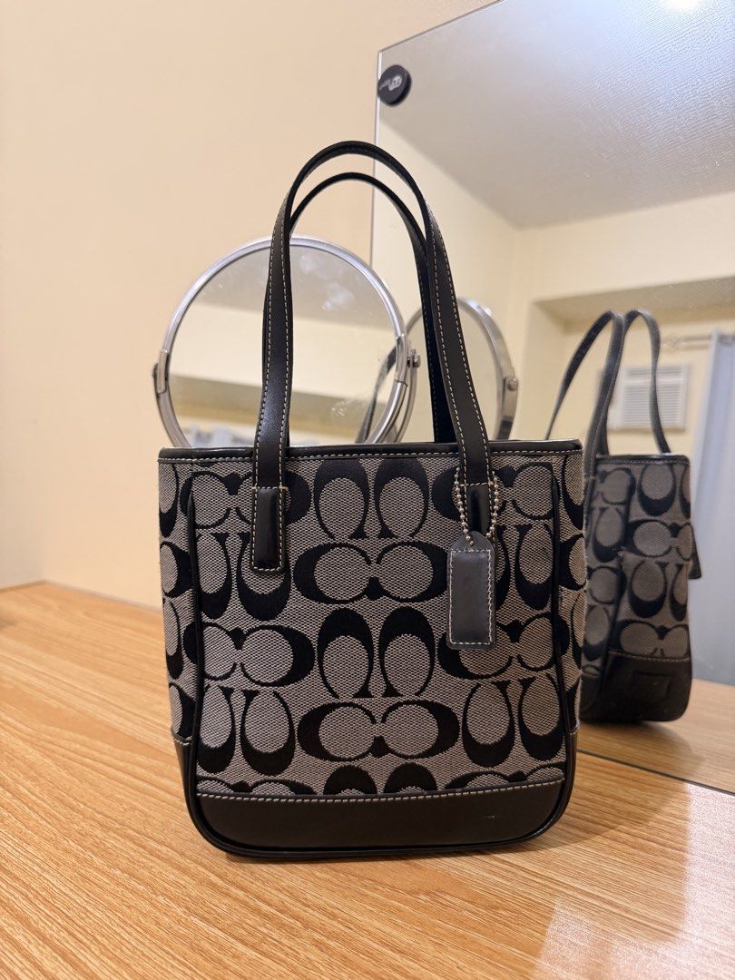 Coach Monogram Canvas Leather Trim Tote Bag (Category: Luxury Bags & Wallets) located in Manila. Submitted by jasminsant59850 (Listing ID 1457426804, Image 2). Description: - vintage Coach Signature Mini Lunch Tote - Signature monogram canvas - Black leather trim and handles - Small size, ideal for everyday essentials - Clean interior - Comes with a Coach hangtag - A timeless and versatile piece.