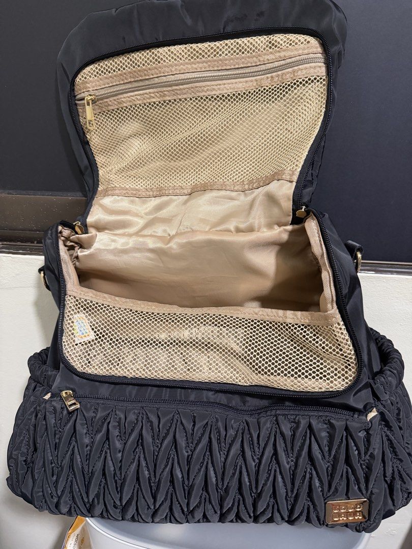 Cocolala Kyler Diaper Bag (Category: Diaper Bags & Wetbags) located in Manila. Submitted by mamamiaaaaa27 (Listing ID 1457465499, Image 2). Description: Bought it at the Baby Company baby fair. - Color: Black - Dimensions: 17”L x 5”W x 12”H - Material: Water resistant nylon fabric - Backpack type - Comes with a cross body strap and detachable stroller straps - Changing pad unused and kept in storage Only issue: the magnet closure at the back pock