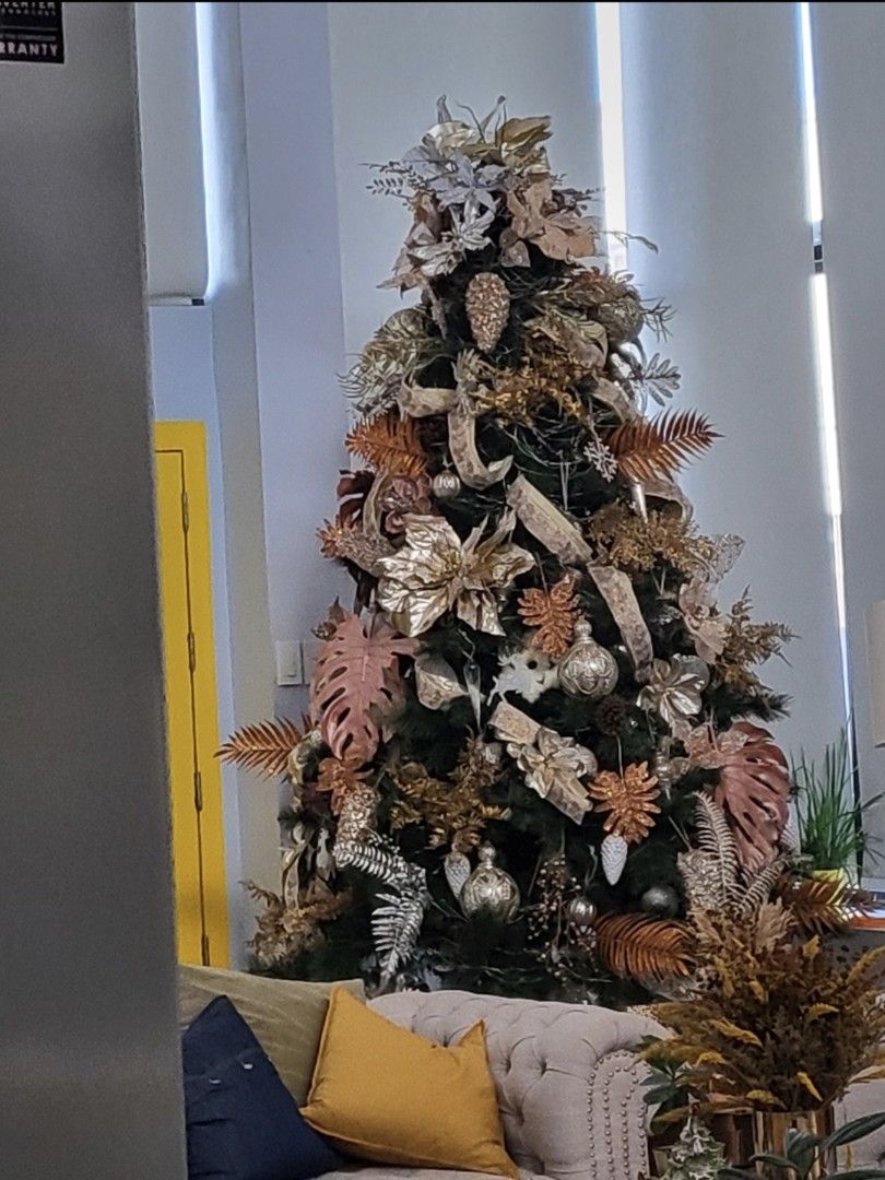 Decorated Christmas Tree with Lights and Ornaments (Category: Other Home Decor) located in Dasmarinas. Submitted by juanitacot13480 (Listing ID 1457337567, Image 3). Description: - Fully decorated 6-7ft Christmas tree - Includes lights, ribbons, pinecones, and ornaments - Ornament colors: gold, silver, and rose gold - Tree skirt is included - Perfect for adding festive cheer - Easy setup.
