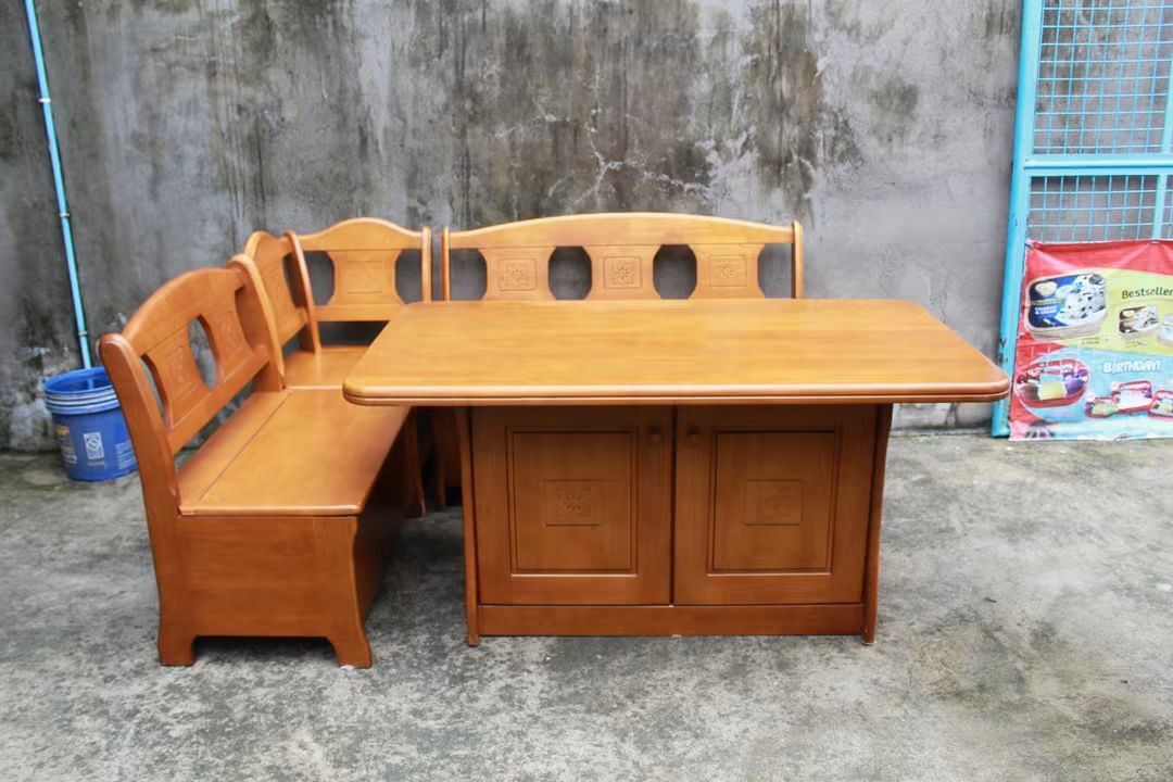 Dining table (Category: Tables & Sets) located in Meycauayan. Submitted by marygracecasimiro (Listing ID 1457420105, Image 3). Description: Solid Wood Corner Dining Set with Storage Spacious table, built-in bench seating and a 2-door storage cabinet underneath. Finished in warm wood tones with elegant carved floral details, plus hidden storage under the bench seats and three-tier shelving inside the cabinet. Perfect for dining areas, breakfast no