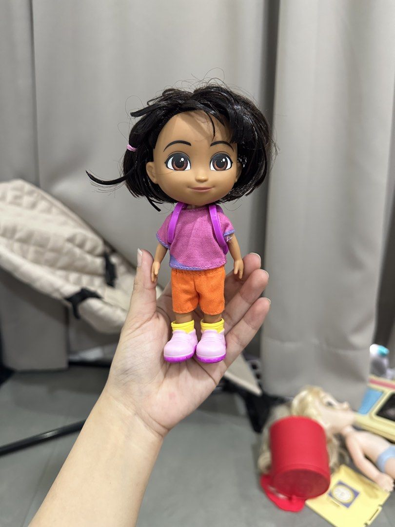 Dora the Explorer Doll with Backpack (Category: Kids Toys) located in Cavite. Submitted by prelovedbymaeve (Listing ID 1457512344, Image 1). Description: - Classic Dora the Explorer doll - Signature outfit: pink shirt, orange shorts, pink boots - Iconic backpack with a smiley face design - Hair is slightly messy - Ideal for any Dora the Explorer enthusiast.