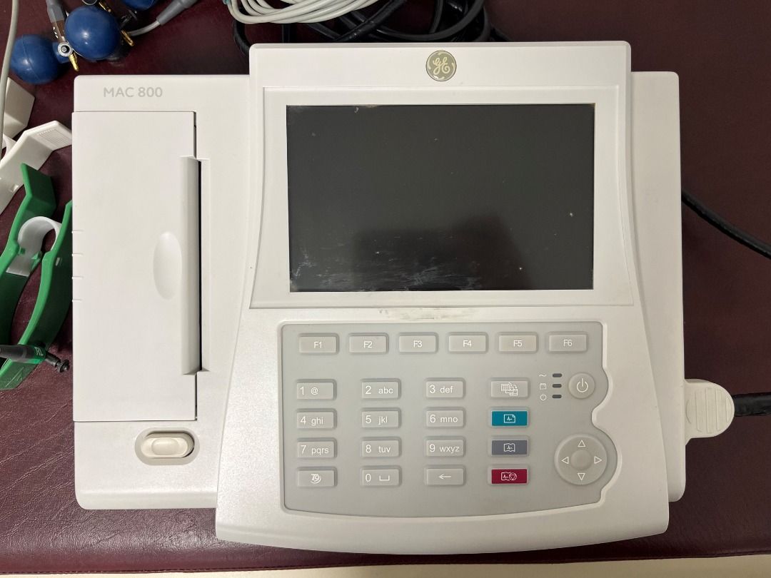 GE MAC 800 ECG Machine (Category: Medical Supplies & Tools) located in Quezon City. Submitted by qc_usedsurplusmaterials.ph (Listing ID 1457404429, Image 1). Description: GE MAC 800 ECG Machine Reliable and compact ECG machine from a trusted medical equipment brand. Current Condition: Unit is working and powers on ECG functions operational Printer not tested Battery not tested (used while plugged in) Power cord/wiring has visible cracks due to ag
