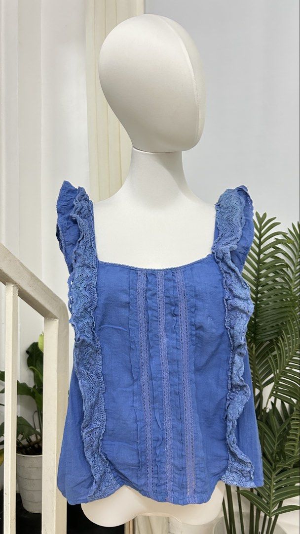 GEORGE Blue Ruffle Lace Trim Square Neck Boho Top Large (Category: Blouses) located in San Jose del Monte. Submitted by vanessabarredo (Listing ID 1457370522, Image 3). Description: George by ASDA blue sleeveless top with a feminine square neckline, ruffled shoulder straps, and delicate lace/crochet trim detailing down the front. Relaxed, slightly flared silhouette with a soft boho / romantic summer feel. Easy to pair with denim shorts, white tro