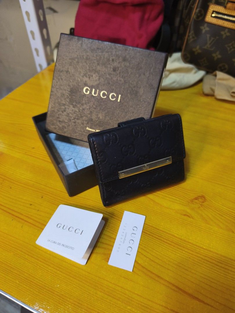 Gucci GG Embossed Leather Bi-Fold Wallet (Category: Luxury Bags & Wallets) located in Baguio. Submitted by junluxgarmsbags108 (Listing ID 1457343773, Image 1). Description: - Authentic Gucci bi-fold wallet - Black leather with signature GG embossing - Gold-tone hardware detail - Comes with original box and authenticity cards - Perfect for organizing essentials.