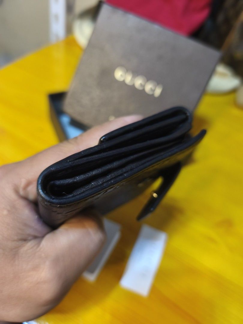 Gucci GG Embossed Leather Bi-Fold Wallet (Category: Luxury Bags & Wallets) located in Baguio. Submitted by junluxgarmsbags108 (Listing ID 1457343773, Image 3). Description: - Authentic Gucci bi-fold wallet - Black leather with signature GG embossing - Gold-tone hardware detail - Comes with original box and authenticity cards - Perfect for organizing essentials.