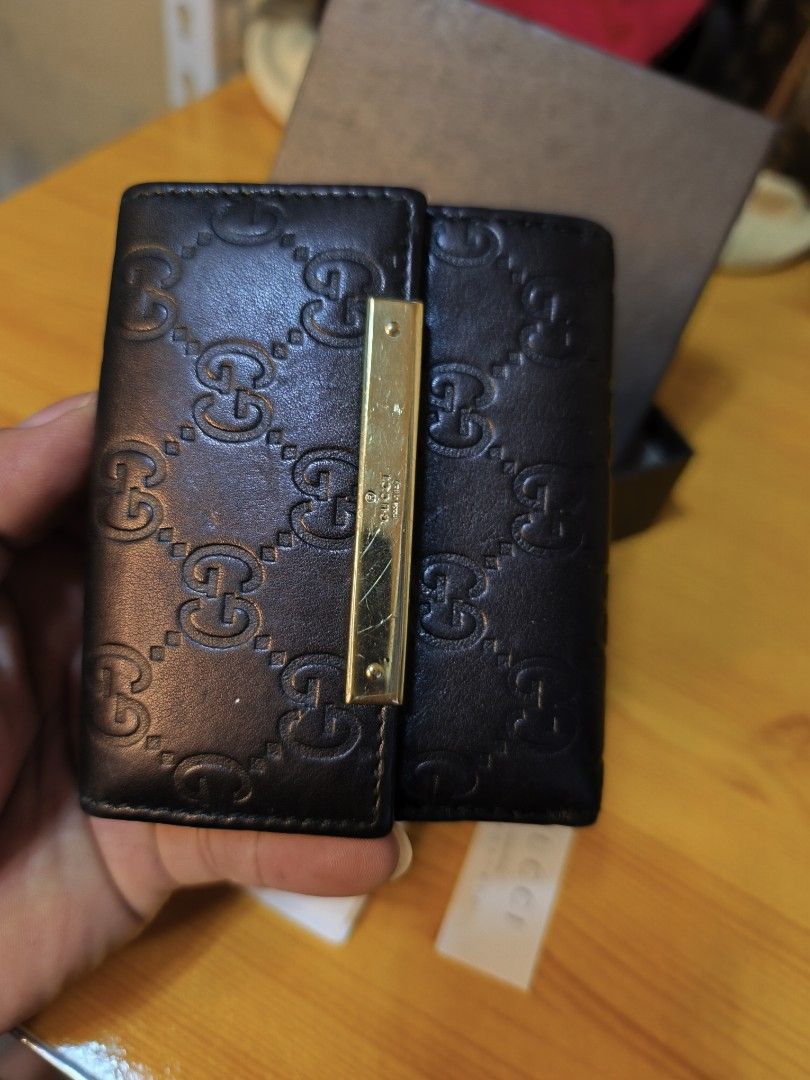 Gucci GG Embossed Leather Bi-Fold Wallet (Category: Luxury Bags & Wallets) located in Baguio. Submitted by junluxgarmsbags108 (Listing ID 1457343773, Image 2). Description: - Authentic Gucci bi-fold wallet - Black leather with signature GG embossing - Gold-tone hardware detail - Comes with original box and authenticity cards - Perfect for organizing essentials.
