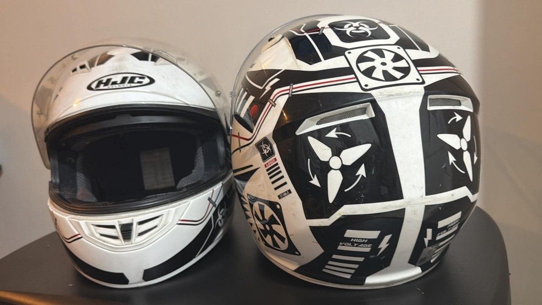 HJC Motorcycle Helmets (2x) - White with Graphics (Category: Helmets and other Riding Gears) located in Pasig City. Submitted by nuttyyy (Listing ID 1457482615, Image 2). Description: - Two HJC full-face motorcycle helmets (original) - White base with striking black and red graphics - Features fan and high voltage designs - Equipped with clear visors - Comfortable interior padding - Perfect for riders looking for a matching set -2XL and Large siz