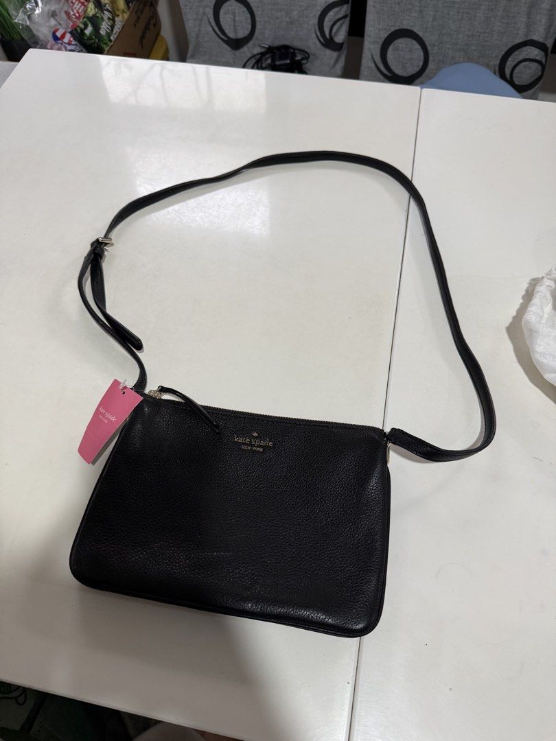 Kate Spade Black Leather Crossbody Bag (Category: Cross-body Bags) located in Cainta. Submitted by declutterwithaly (Listing ID 1457464073, Image 2). Description: - Brand: Kate Spade New York - Material: Black pebbled leather - Hardware: Gold tone - Closure: Zip - Interior: Multiple card slots - Strap: Adjustable - Condition: New with original tag - Ideal for: Everyday use or travel.
