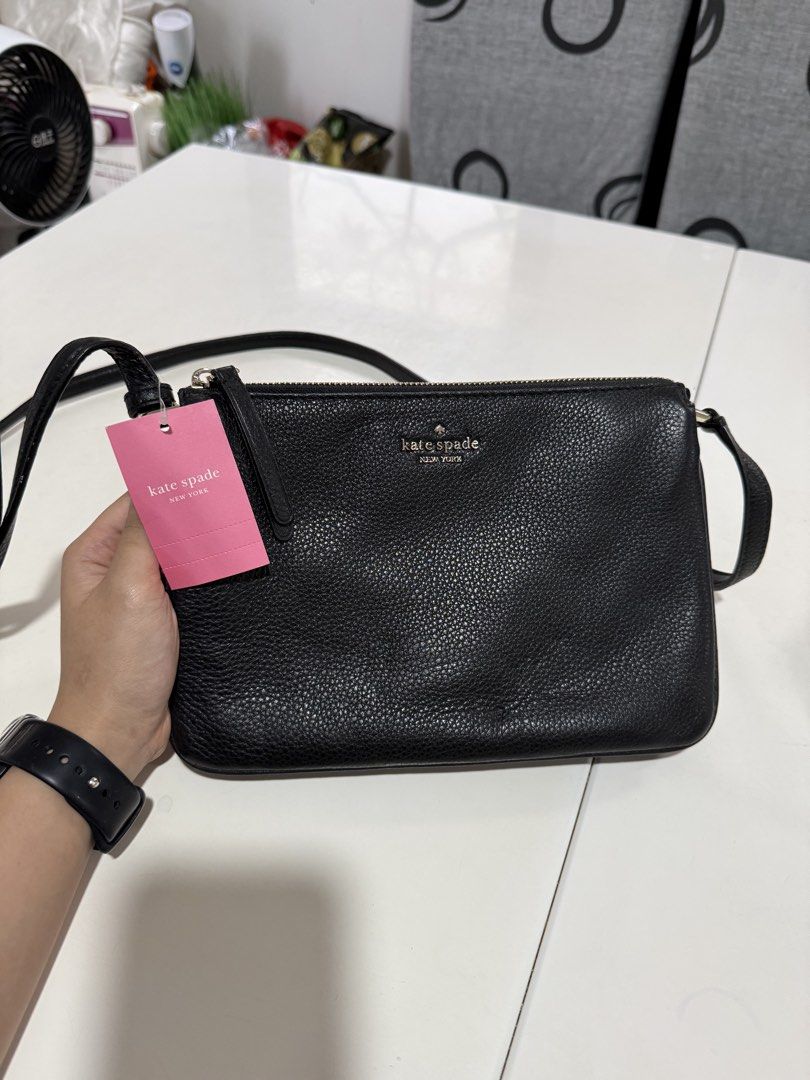 Kate Spade Black Leather Crossbody Bag (Category: Cross-body Bags) located in Cainta. Submitted by declutterwithaly (Listing ID 1457464073, Image 1). Description: - Brand: Kate Spade New York - Material: Black pebbled leather - Hardware: Gold tone - Closure: Zip - Interior: Multiple card slots - Strap: Adjustable - Condition: New with original tag - Ideal for: Everyday use or travel.