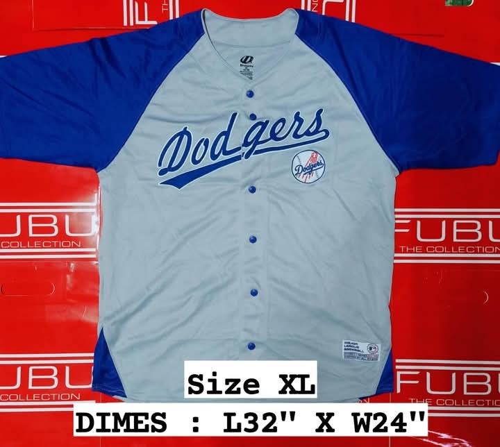 Los Angeles Dodgers Baseball Jersey XL (Category: Tshirts & Polo Shirts ) located in Caloocan City. Submitted by ridegwanna17045 (Listing ID 1457390563, Image 1). Description: - Dodgers Baseball Jersey - Size: XL - Color: Light Grey with Blue Sleeves and Trim - Features: Dodgers Logo on Chest - Style: Button-up Front - Approximate Measurements: Length 32", Width 24".