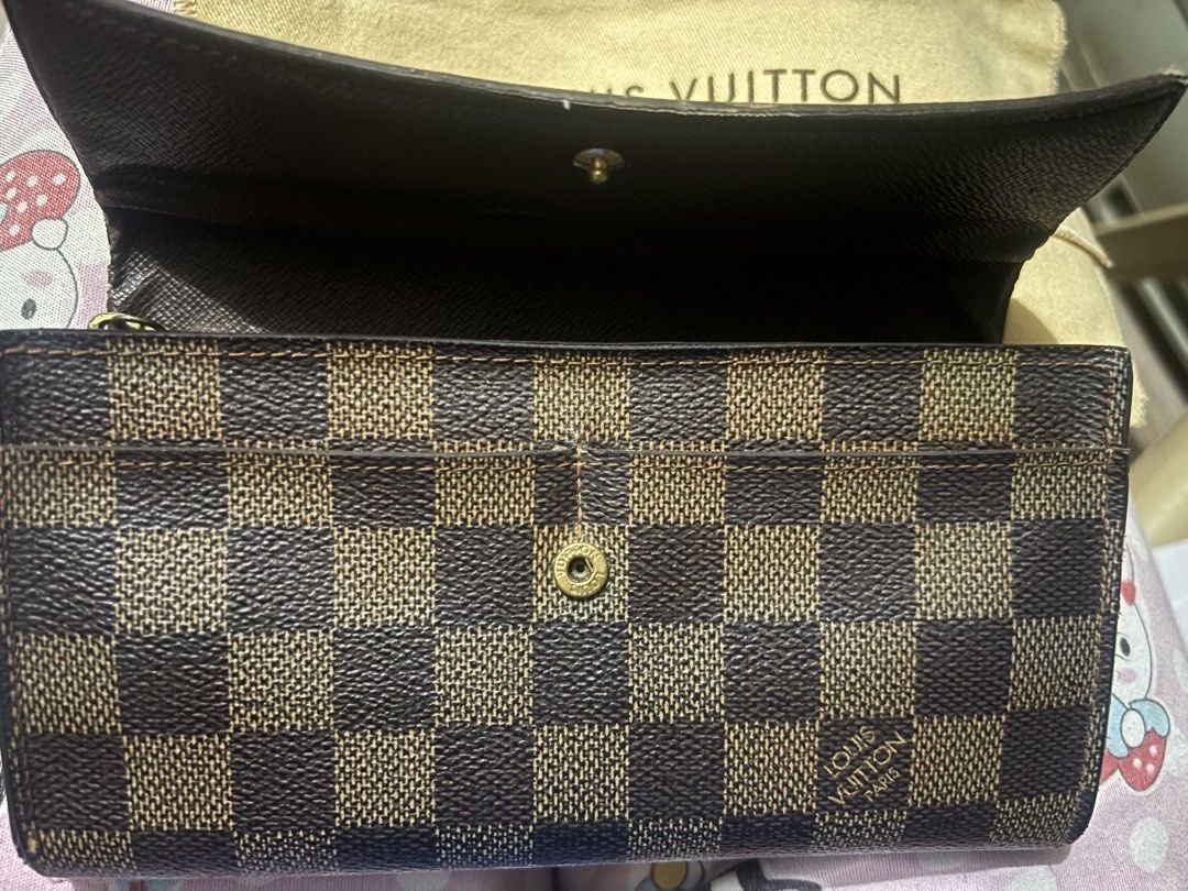 Louis Vuitton Damier Ebene Canvas Long Wallet (Category: Luxury Bags & Wallets) located in Marikina City. Submitted by alloriginalbyshed (Listing ID 1457354425, Image 3). Description: - Authentic Louis Vuitton wallet - Damier Ebene canvas - Secure snap button closure (issue) - Ample card slots and compartments - Zippered coin pocket - Includes dust bag - Perfect for organizing your essentials.
