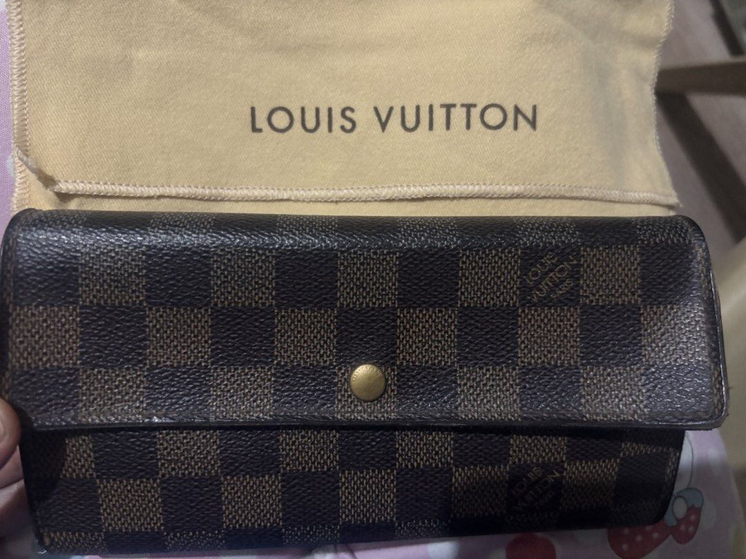 Louis Vuitton Damier Ebene Canvas Long Wallet (Category: Luxury Bags & Wallets) located in Marikina City. Submitted by alloriginalbyshed (Listing ID 1457354425, Image 1). Description: - Authentic Louis Vuitton wallet - Damier Ebene canvas - Secure snap button closure (issue) - Ample card slots and compartments - Zippered coin pocket - Includes dust bag - Perfect for organizing your essentials.