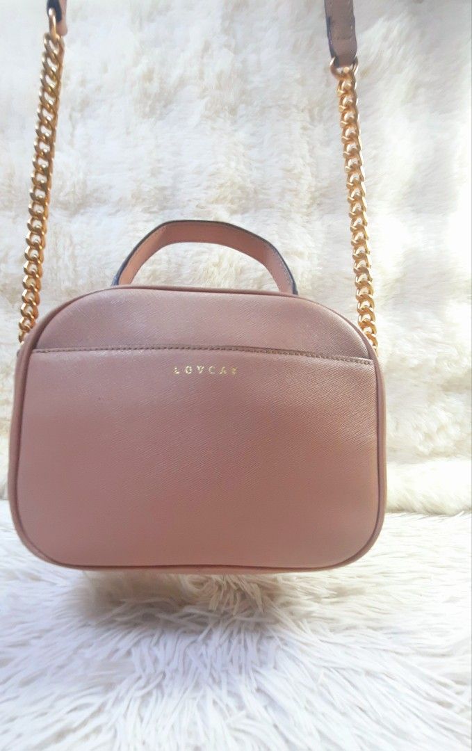 LOVCAT Pink Leather Chain Strap Top Handle Camera Bag (Category: Luxury Bags & Wallets) located in Mandaluyong City. Submitted by styleluxeonlineshop (Listing ID 1457466970, Image 2). Description: - Cute pink LOVCAT bag - Features a top handle - Includes a detachable gold chain strap - Interior zippered pocket and slip pockets - Versatile for everyday or evening use - Clean inside and out - Ready for a new owner.