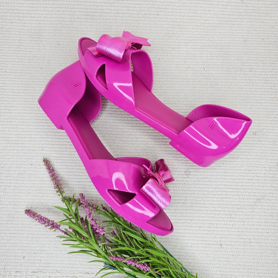 Melissa Pink Jelly Bow Sandals Flats (Category: Flats & Sandals) located in Baguio. Submitted by mybirken.stuffph (Listing ID 1457486450, Image 3). Description: - Cute pink Melissa jelly sandals - Features a shiny bow detail - Easy slip-on style - Perfect for casual wear - Minor scuffs on bows, overall good appearance.