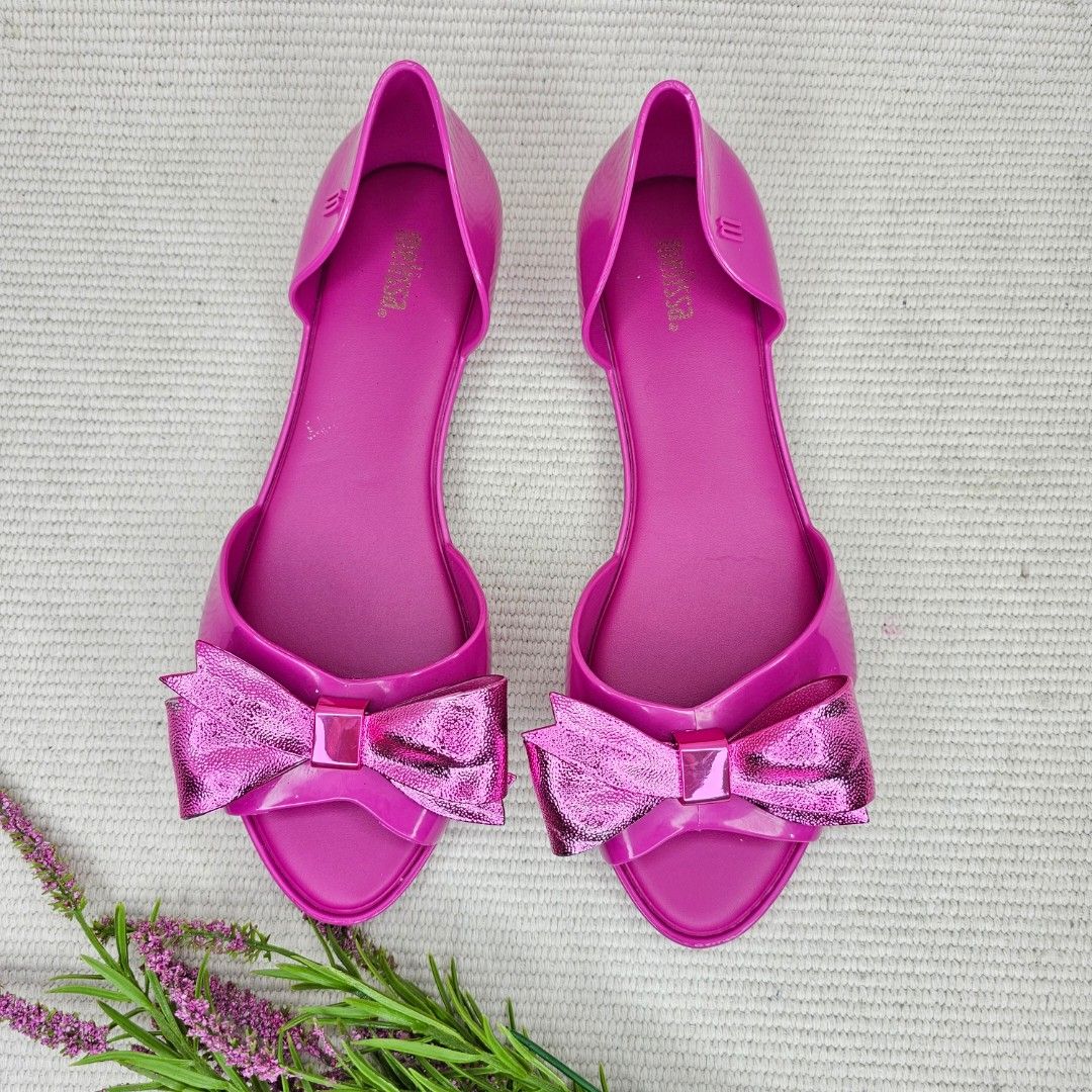 Melissa Pink Jelly Bow Sandals Flats (Category: Flats & Sandals) located in Baguio. Submitted by mybirken.stuffph (Listing ID 1457486450, Image 2). Description: - Cute pink Melissa jelly sandals - Features a shiny bow detail - Easy slip-on style - Perfect for casual wear - Minor scuffs on bows, overall good appearance.
