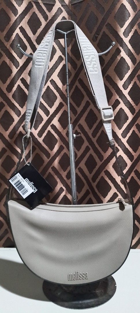 Melissa Transparent Shoulder Bag (Category: Shoulder Bags) located in Pavia. Submitted by taurusgirl74 (Listing ID 1457347214, Image 1). Description: - Melissa shoulder bag - Color: Light beige and transparent - Closure: Zipper on top - Strap: Adjustable - Details: Melissa logo on front and strap, 'Since 1979' on the side.