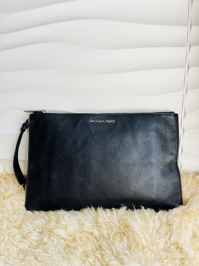 Michael Kors Black Leather Wristlet Clutch (Category: Clutches) located in Davao. Submitted by goodthingsph_ (Listing ID 1457342614, Image 1). Description: - Genuine black pebbled leather Michael Kors clutch 14x9” - Detachable wrist strap for versatility - Secure zip-around closure - Interior zip pocket and card slots for organization - Elegant silver-tone hardware - Ideal size for carrying your daily essentials.